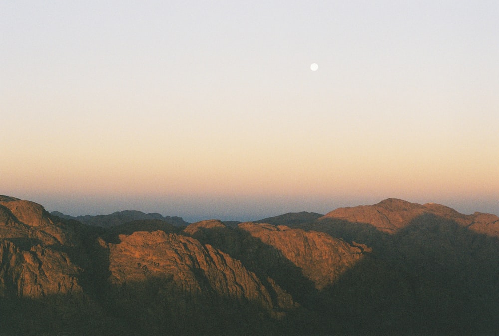 green and brown mountains under white sky during daytime