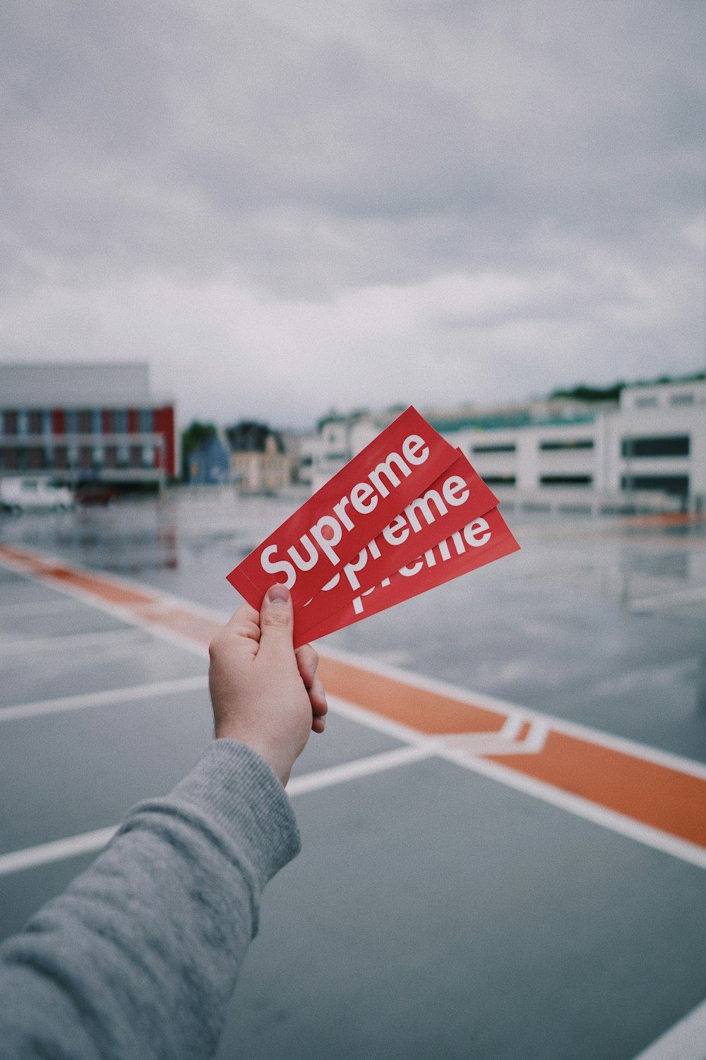 person holding red and white no smoking sign