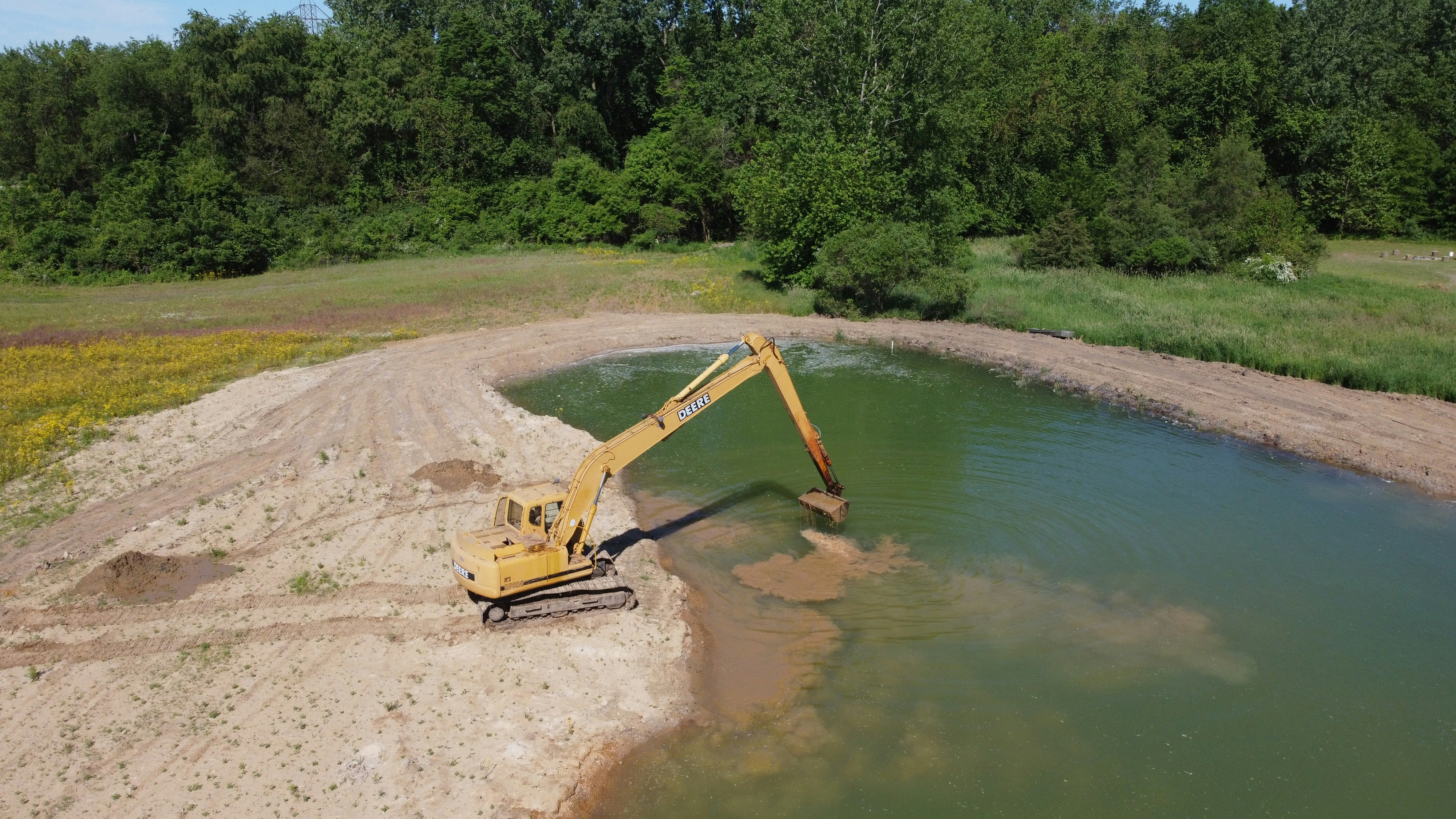 yellow crane near body of water during daytime