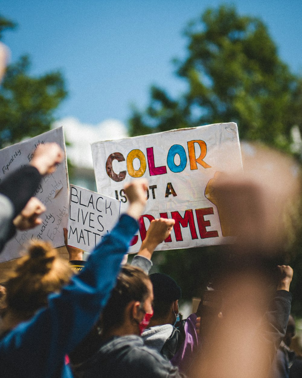 people holding white and blue t-2 p printed paper during daytime