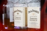 Several bottles are arranged side by side, prominently featuring Jack Daniel's Tennessee Honey whiskey with clear branding and labels in view.