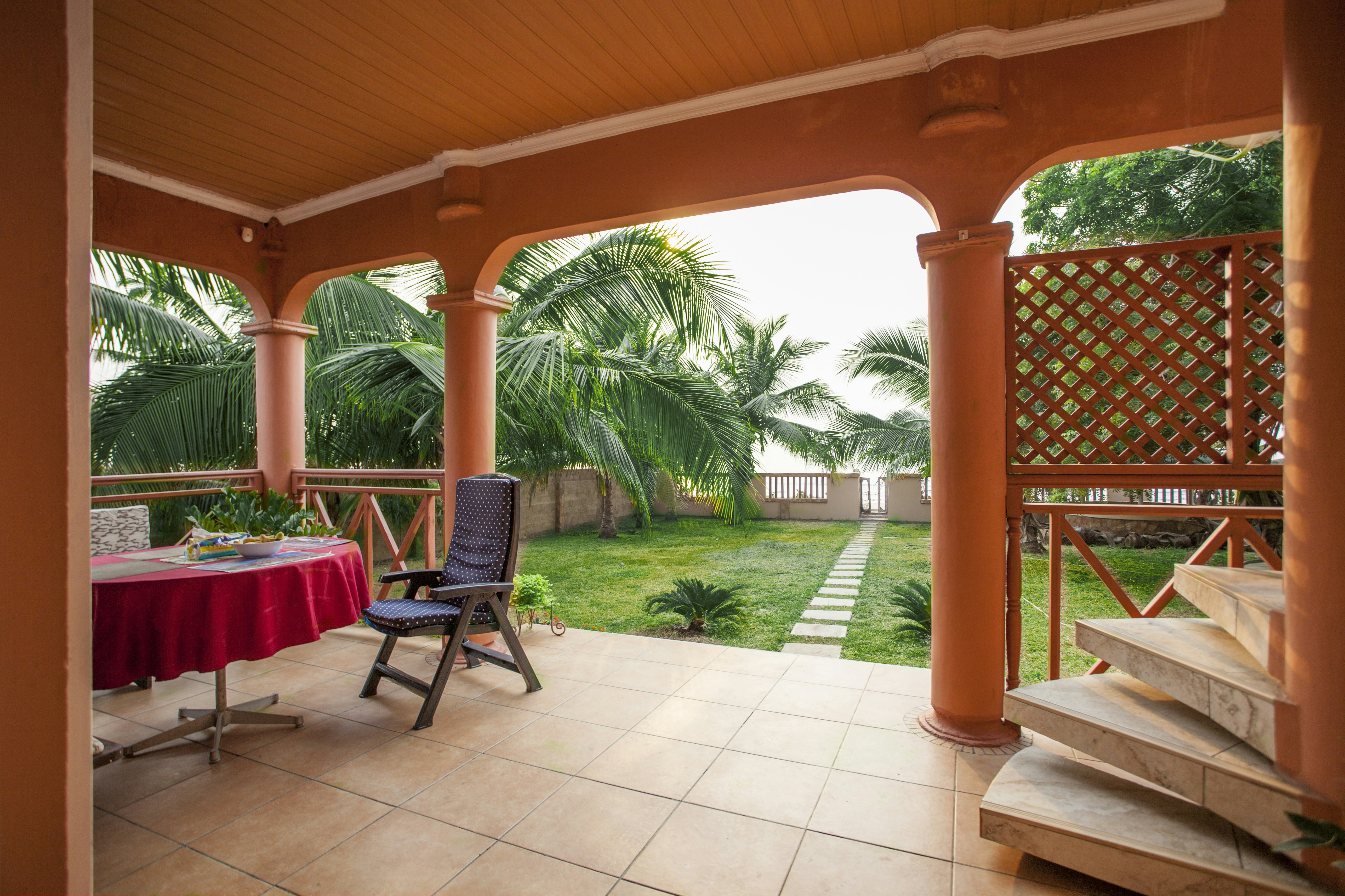 Covered alfresco area with outdoor kitchen and garden outlook