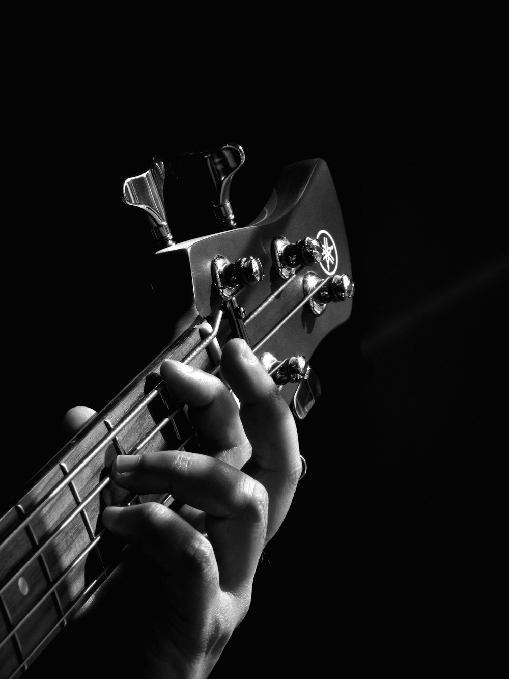 person playing guitar grayscale photo