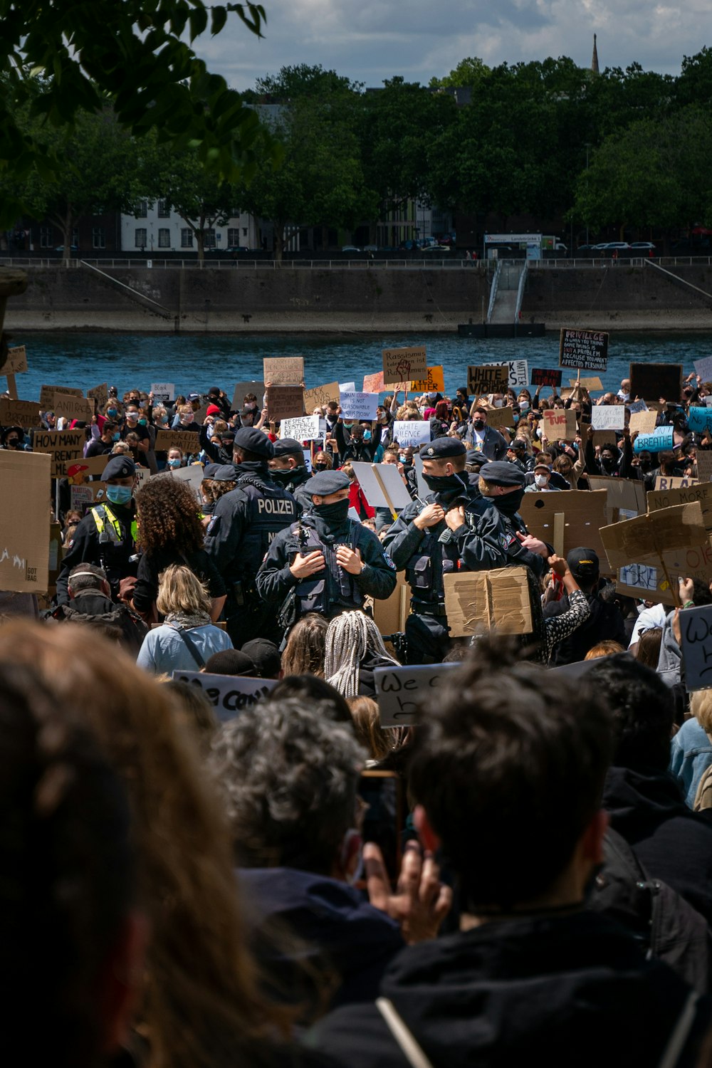 people sitting on chair near body of water during daytime