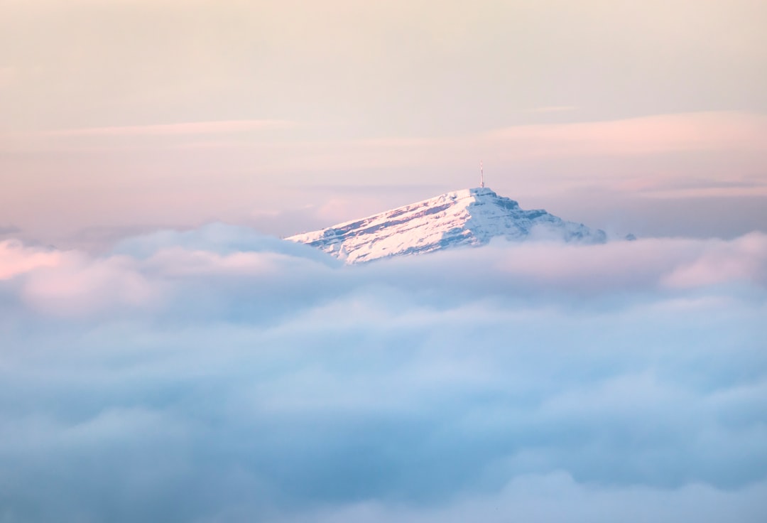 snow covered mountain under cloudy sky during daytime