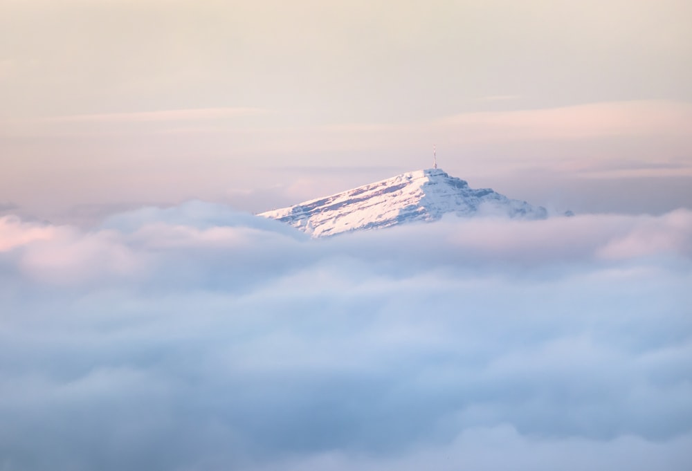 snow covered mountain under cloudy sky during daytime