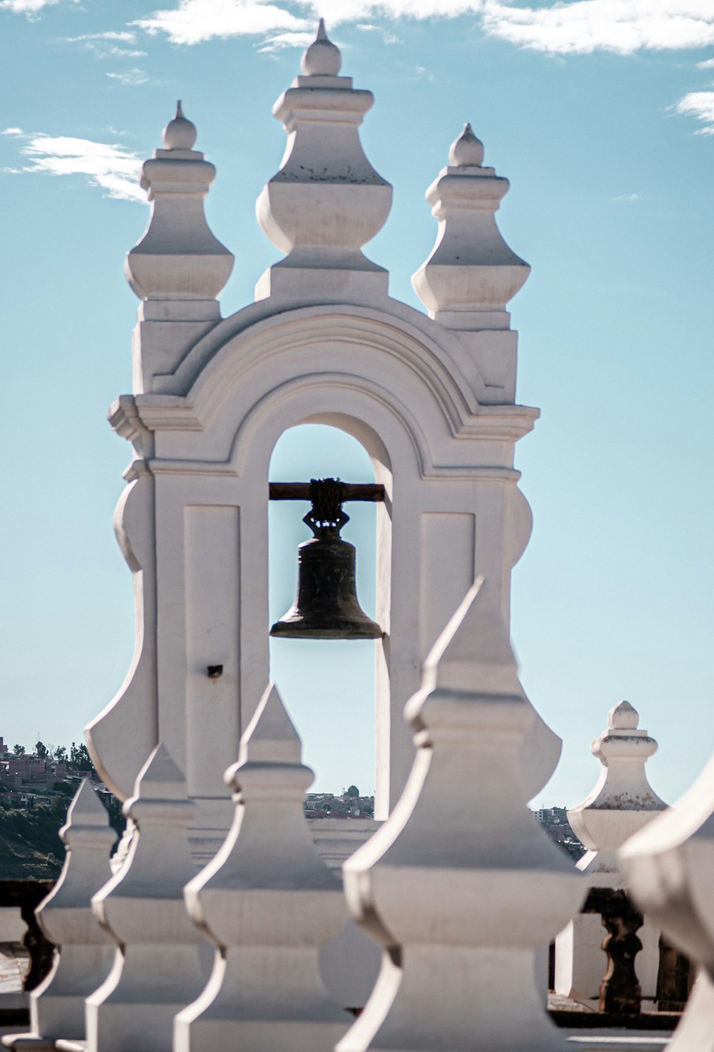 white concrete bell under blue sky during daytime