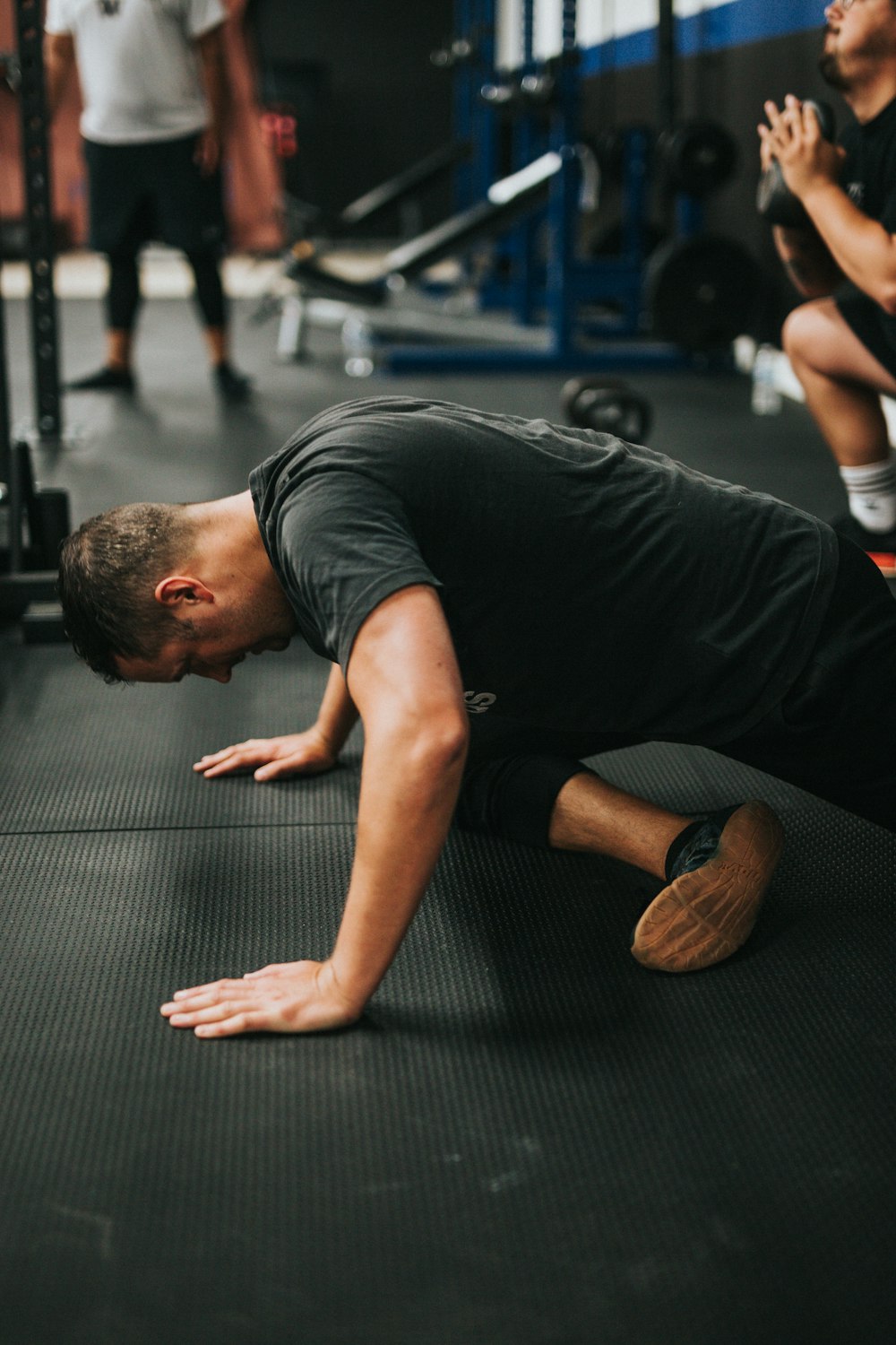 man in black t-shirt and black pants sitting on floor