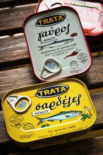 person holding yellow and white can