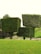Three large, neatly trimmed box-shaped hedges stand in a grassy area, with a backdrop of natural greenery. The hedges are positioned on sloped terrain, creating a visually striking arrangement.