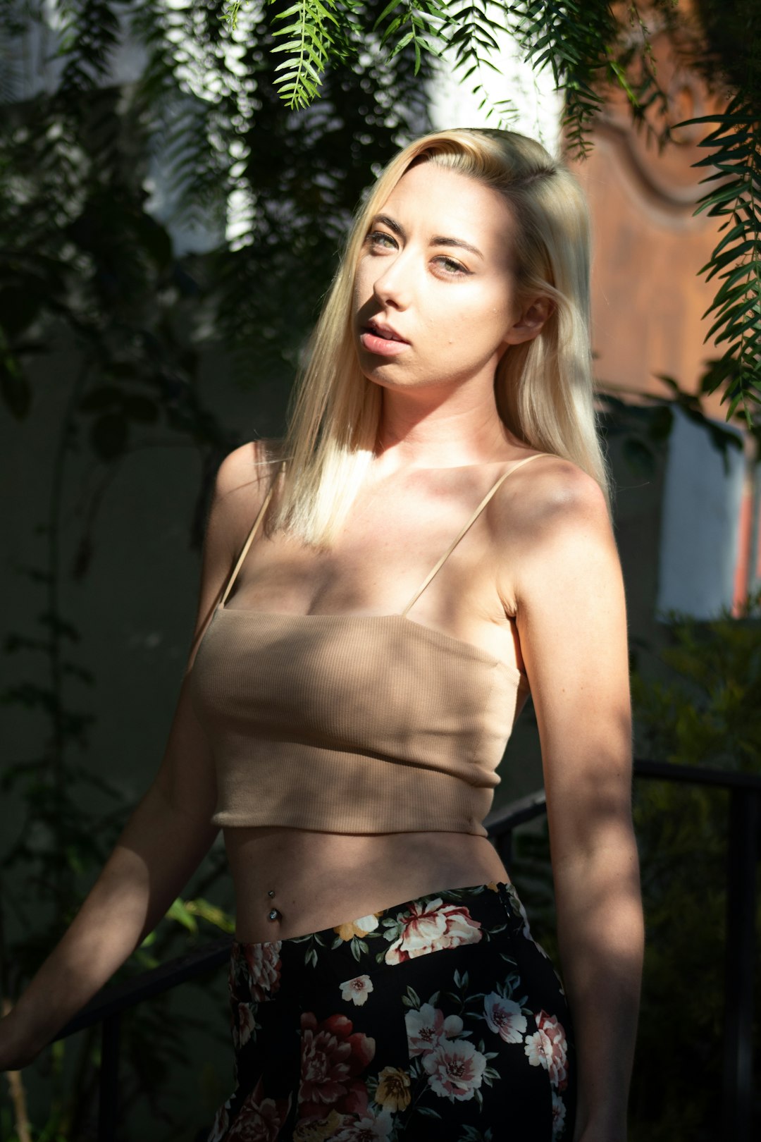 topless woman wearing black and white floral skirt