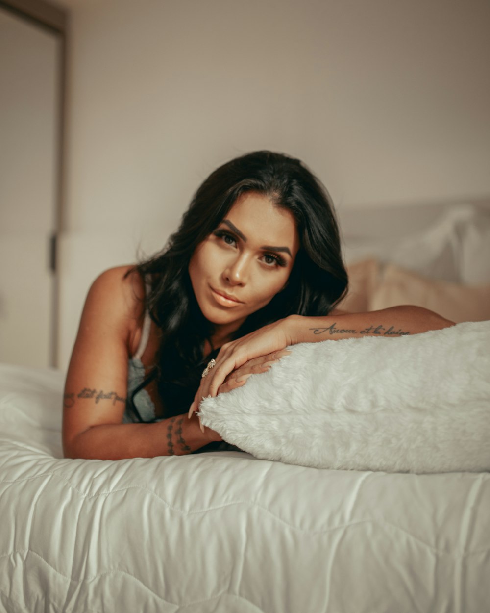 woman in black tank top lying on bed