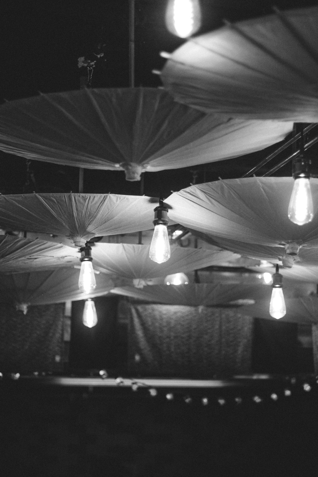 grayscale photo of pendant lamps