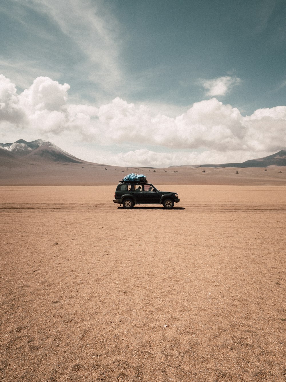 black suv on brown sand during daytime