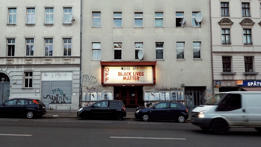 cars parked in front of brown concrete building during daytime in Neukölln Germany