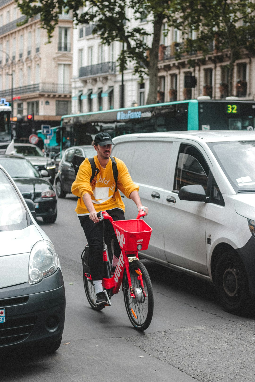 man in yellow polo shirt riding red and white bicycle on road during daytime