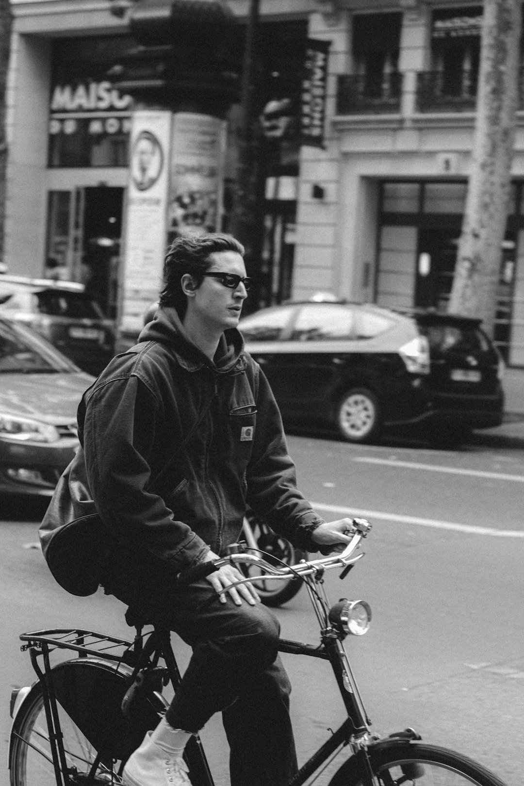 man in black jacket riding on motorcycle in grayscale photography