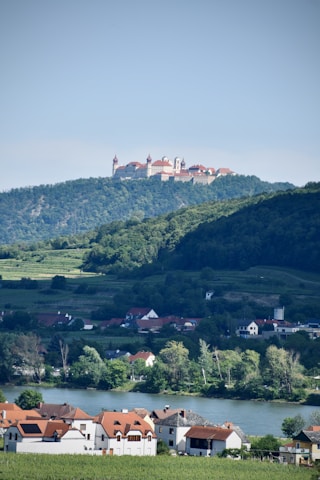 Travelers enjoying a peaceful moment at a colorful monastery perched on a hillside.