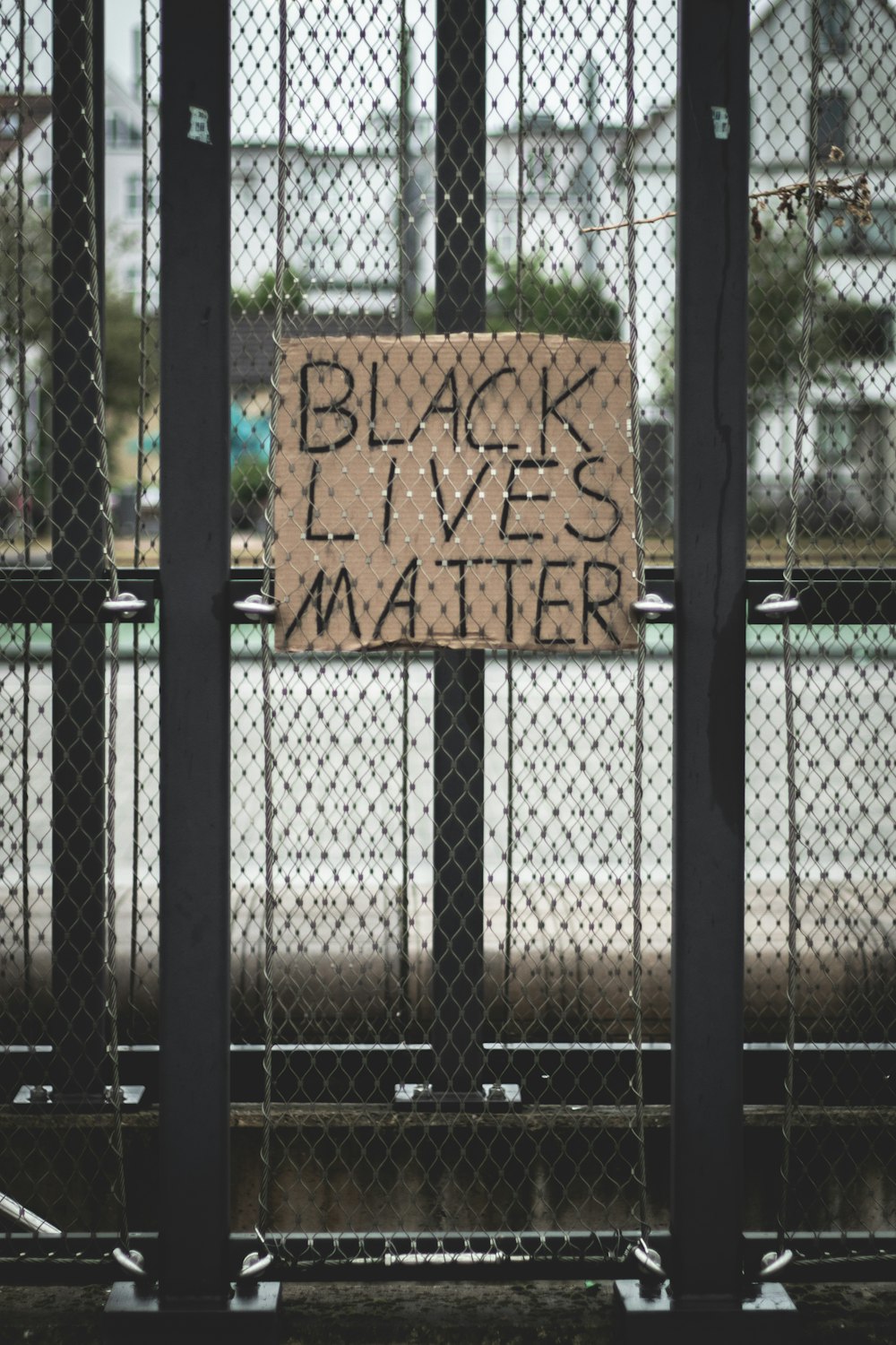 black metal fence with brown wooden signage