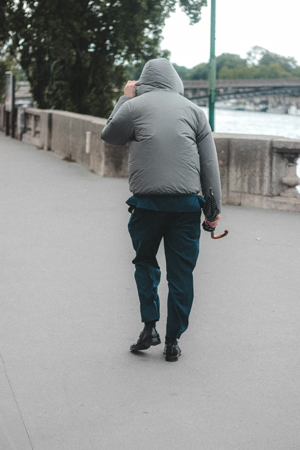 Man in gray hoodie and black pants walking on gray concrete road during  daytime photo – Free France Image on Unsplash
