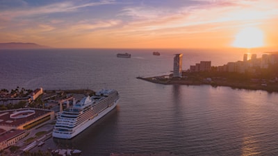 Photo of cruise ships docked at Port Miami under a warm sunset.