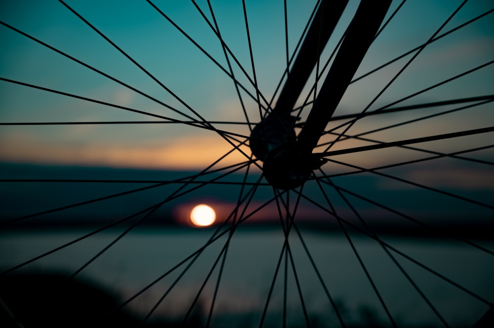 black bicycle wheel during sunset