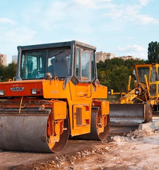 yellow and black heavy equipment on snow covered ground during daytime