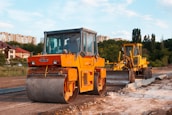 yellow and black heavy equipment on snow covered ground during daytime