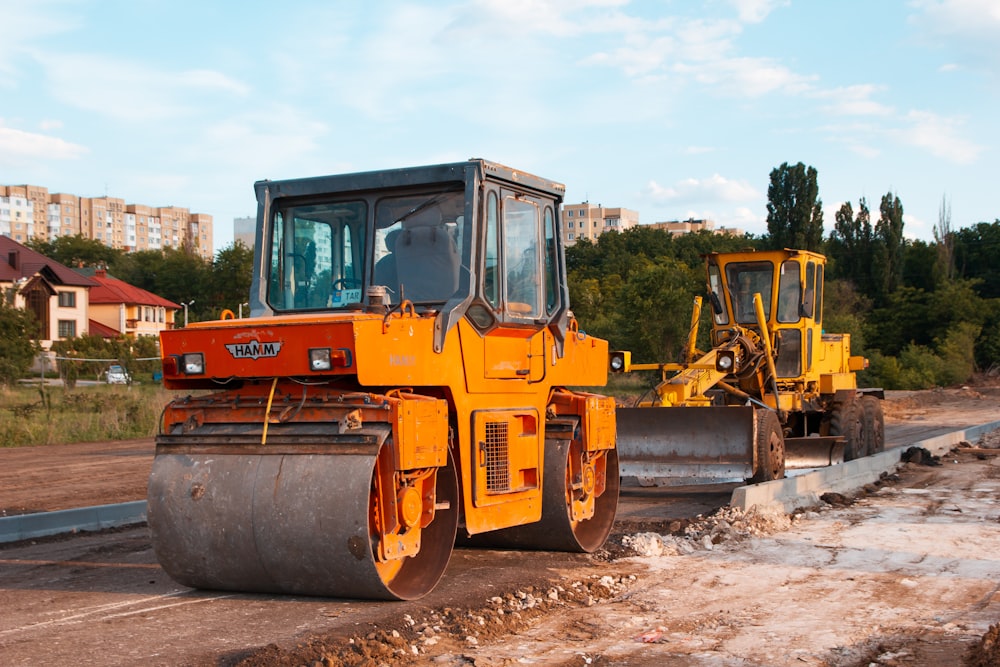 yellow and black heavy equipment on snow covered ground during daytime