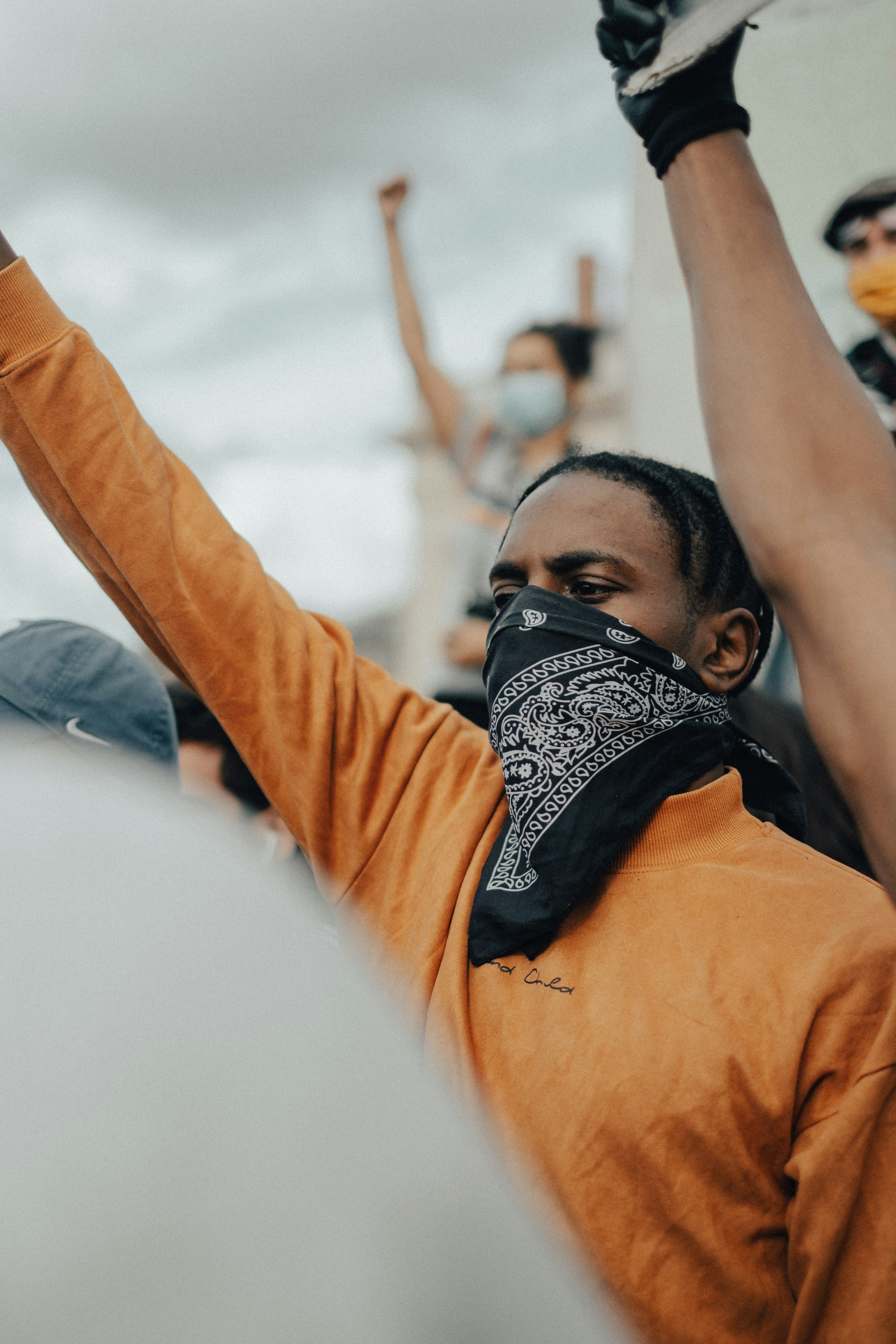 man in orange long sleeve shirt wearing black goggles