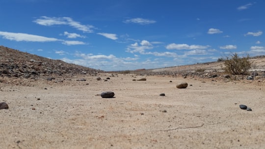 black rock on brown sand under blue sky during daytime in Ruta Provincial 49 Argentina