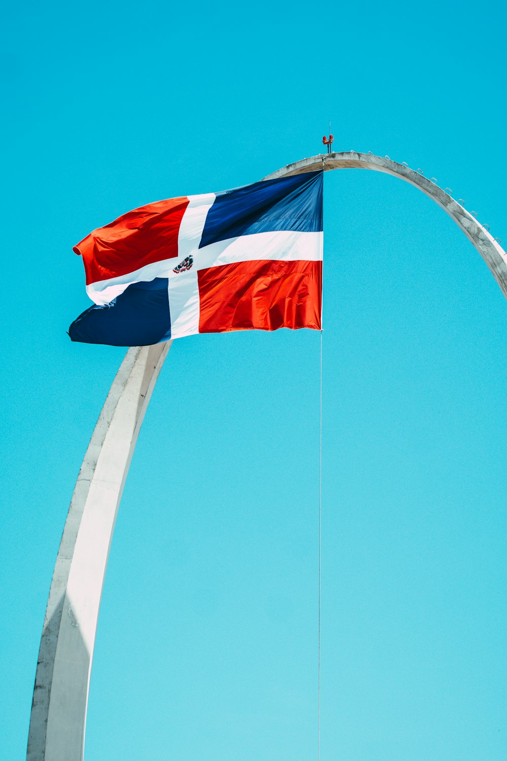 red white and blue flag on pole during daytime