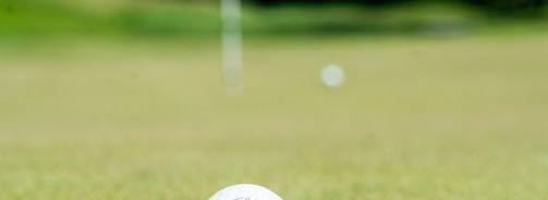 white golf ball on green grass field during daytime