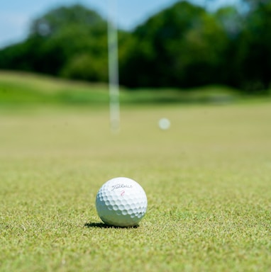 white golf ball on green grass field during daytime