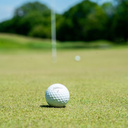 white golf ball on green grass field during daytime