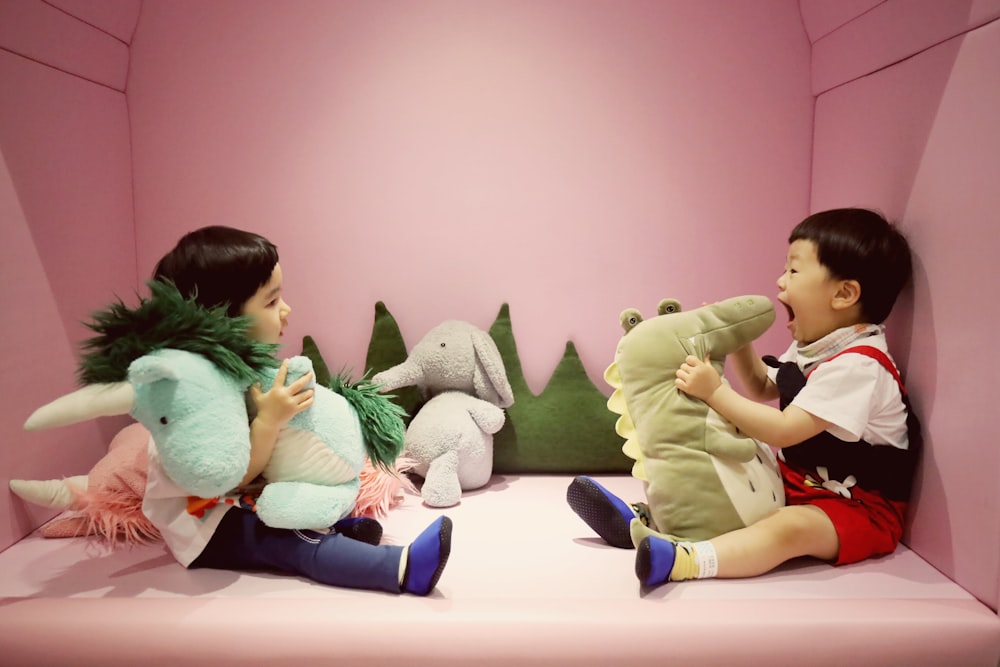 boy in green long sleeve shirt sitting on bed