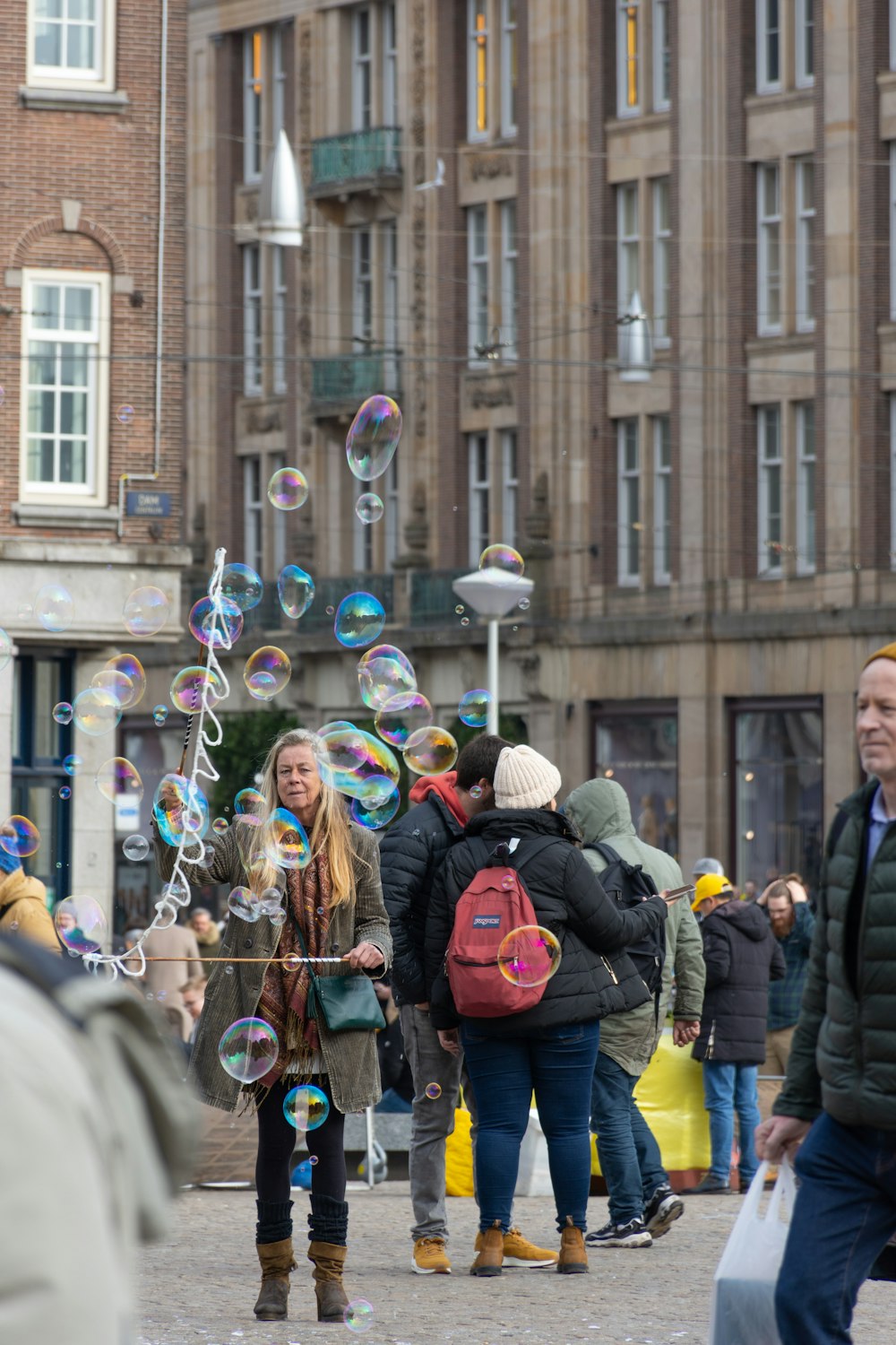 people in bubble jacket standing on street during daytime