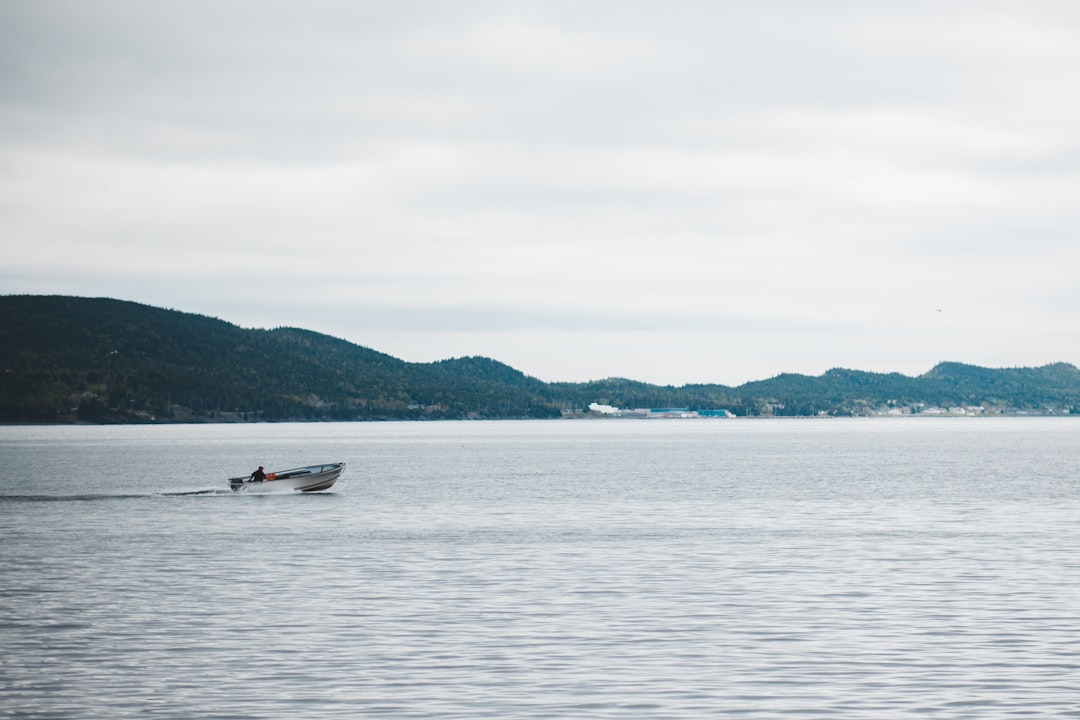 person riding on white and red boat on sea during daytime