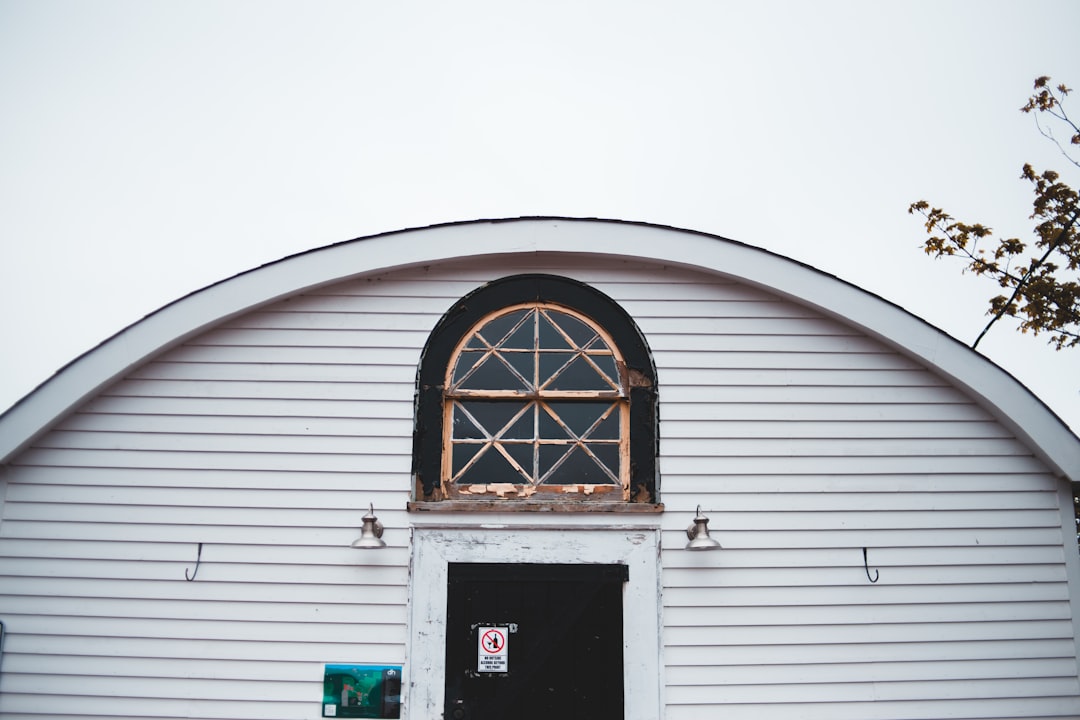 white wooden door on white wooden house