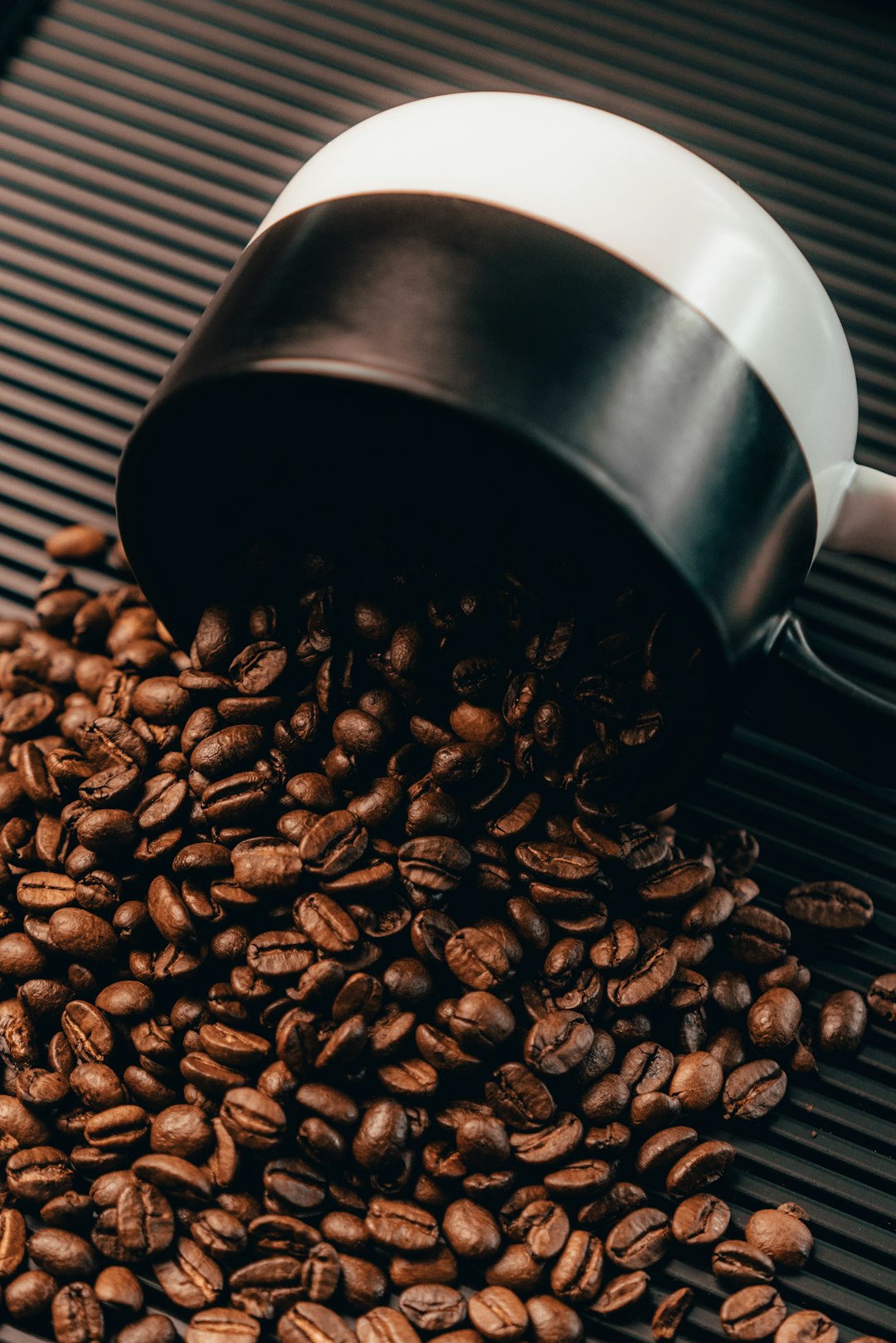 brown coffee beans on stainless steel cup