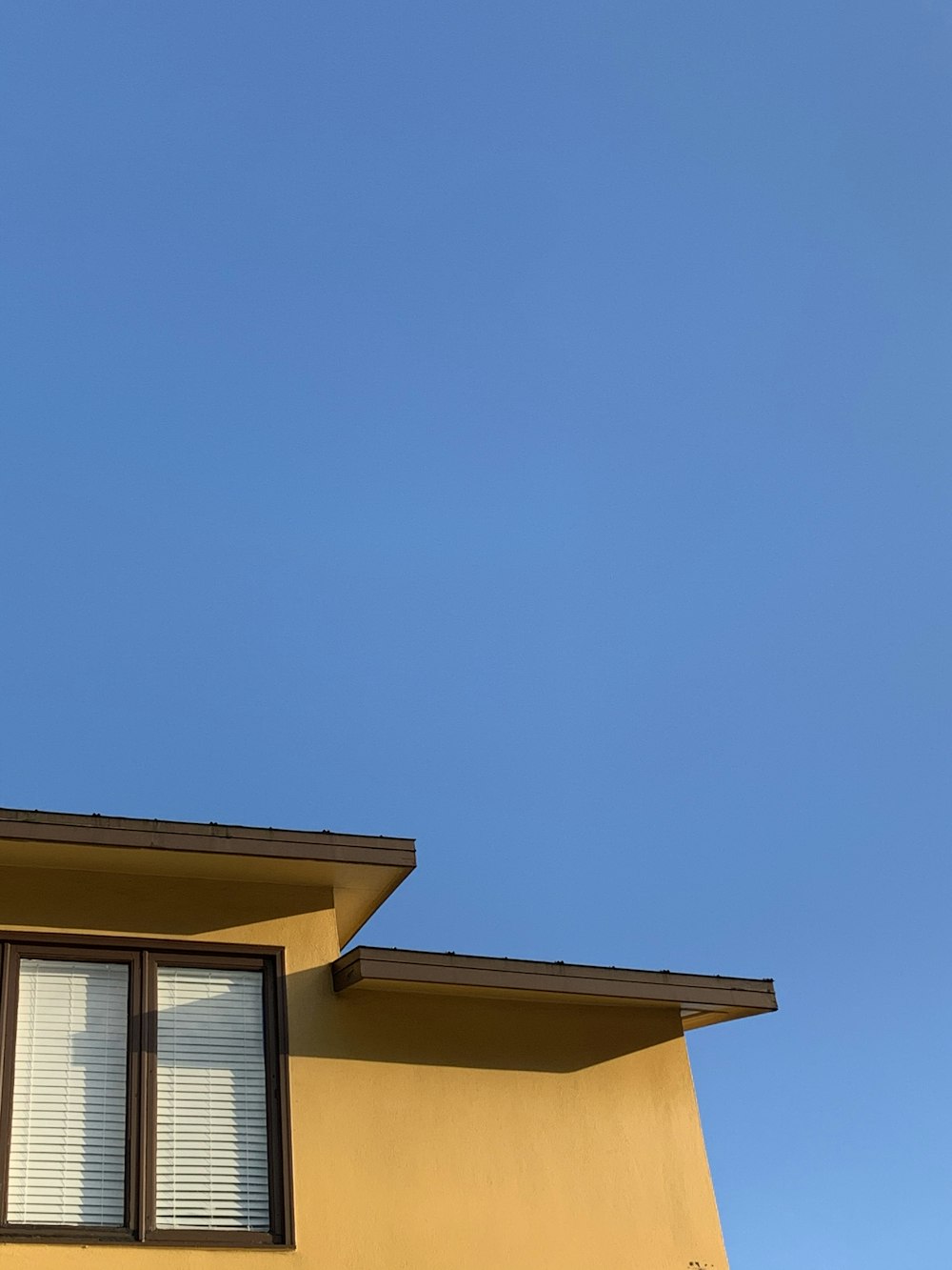 yellow and brown concrete house under blue sky during daytime
