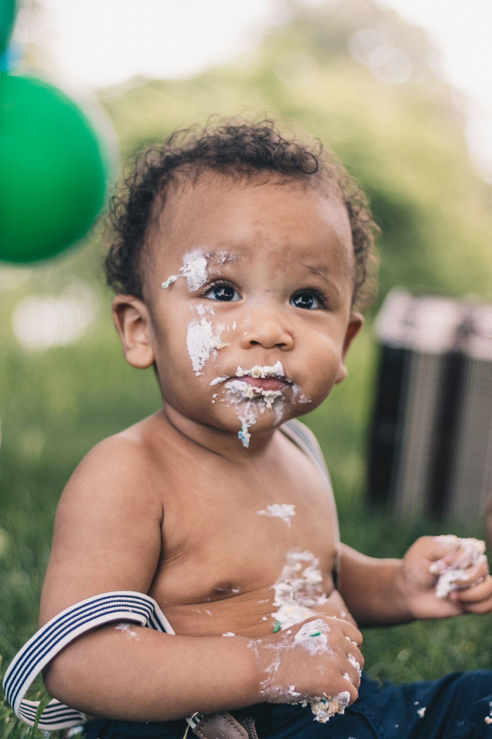 topless boy with white powder on face