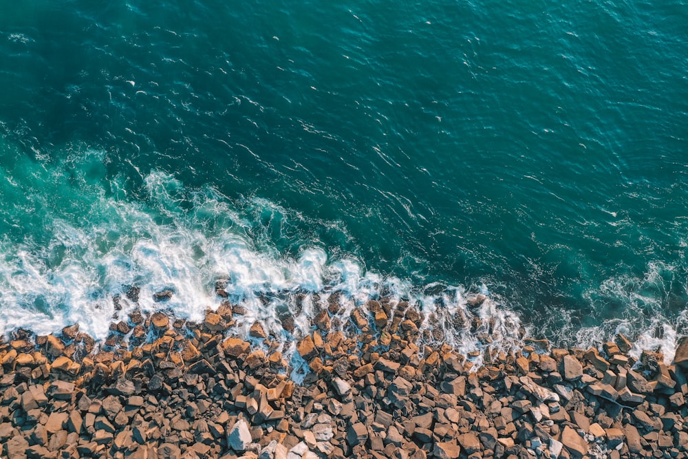 brown rocks on seashore during daytime