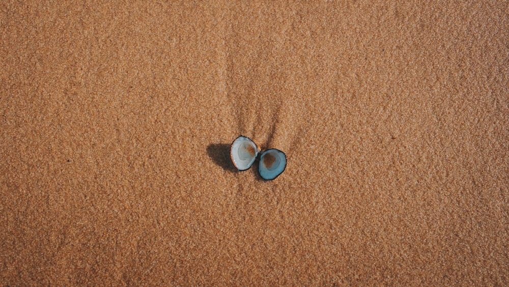 2 pièces rondes bleues et argentées sur textile marron