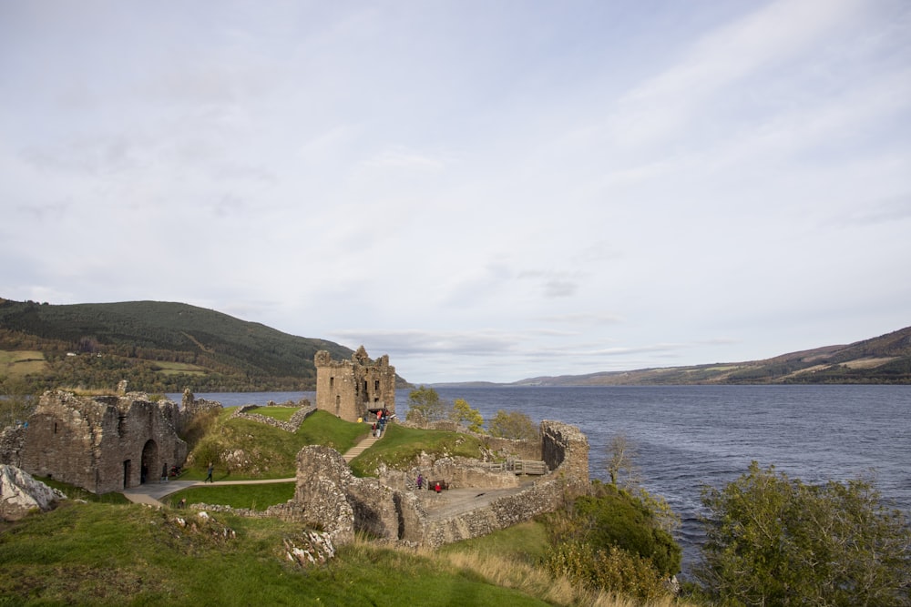 a castle sitting on top of a lush green hillside