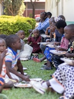 people sitting on green grass during daytime