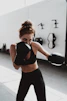 woman in black sports bra and black leggings doing exercise
