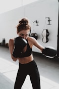 woman in black sports bra and black leggings doing exercise