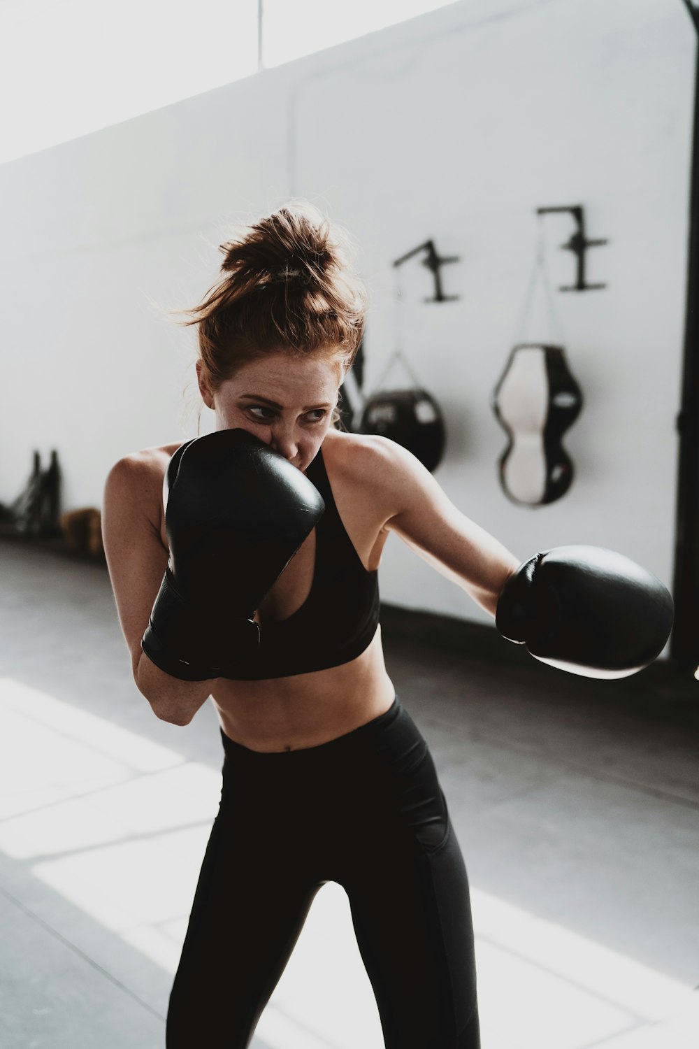 woman in black sports bra and black leggings doing exercise