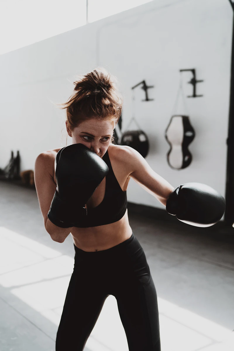 Women practising self-defence strikes on focus pads